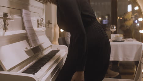 curly woman playing piano at restaurant 2