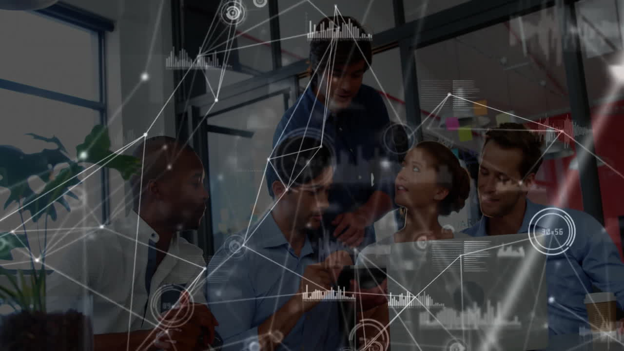 tech team collaborating around desk in modern office, integrating mobile devices with data overlays