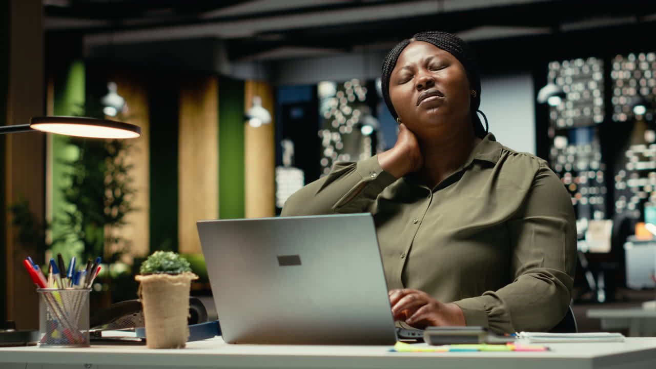 Businesswoman correcting her pose and stretching her neck muscles