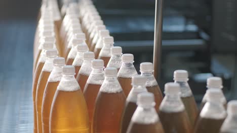 conveyor belt with bottles for juice or water at a modern beverage plant. modern production of sweet soda water