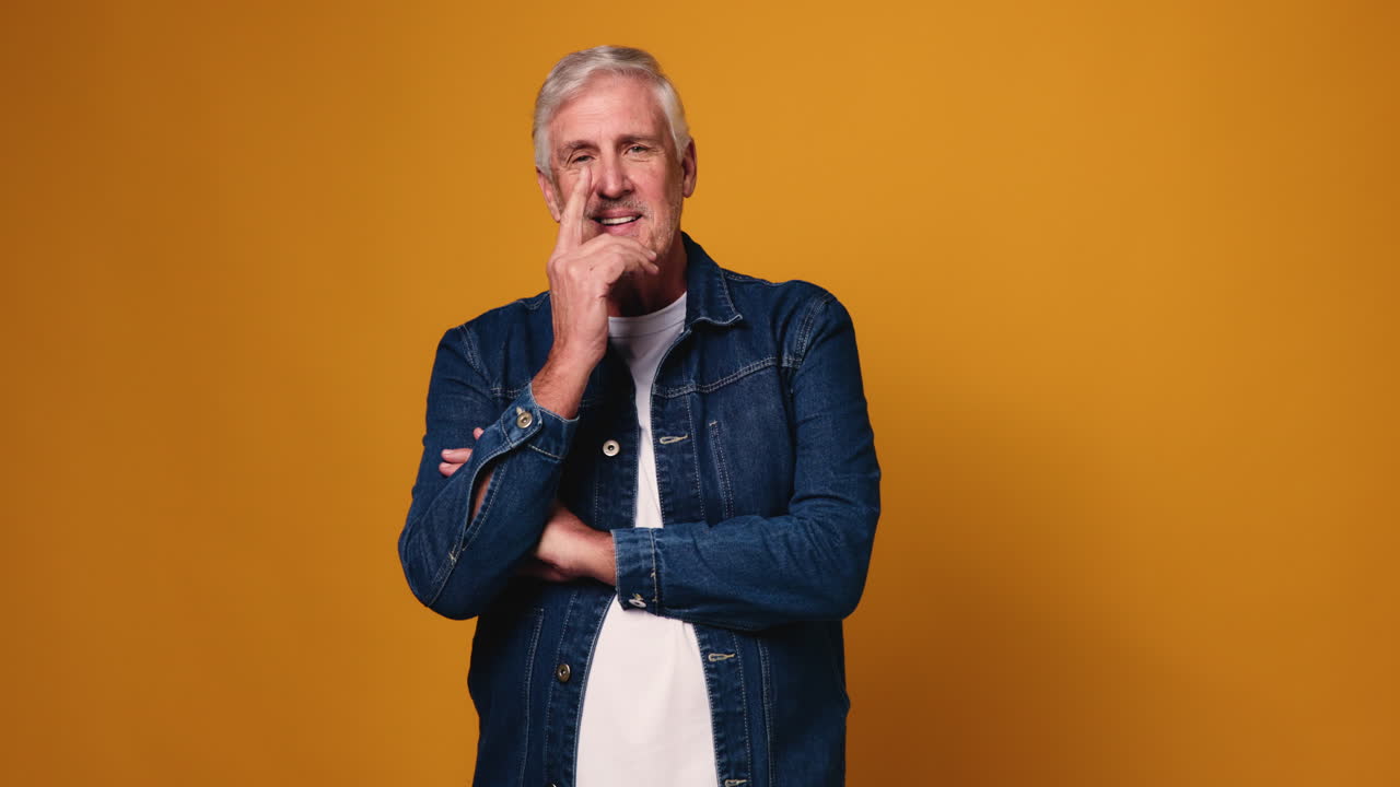 Portrait of a Senior Man in Denim Jacket Thinking