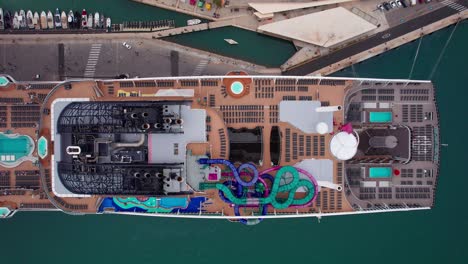 Overhead-Aerial-of-Swimming-Pool-Slides-and-Sunbeds-on-Big-Luxury-Cruise-Ship