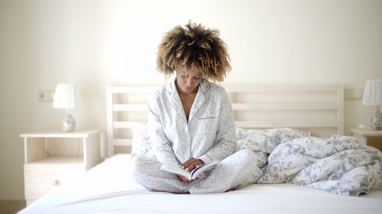 mujer leyendo un libro en la cama
