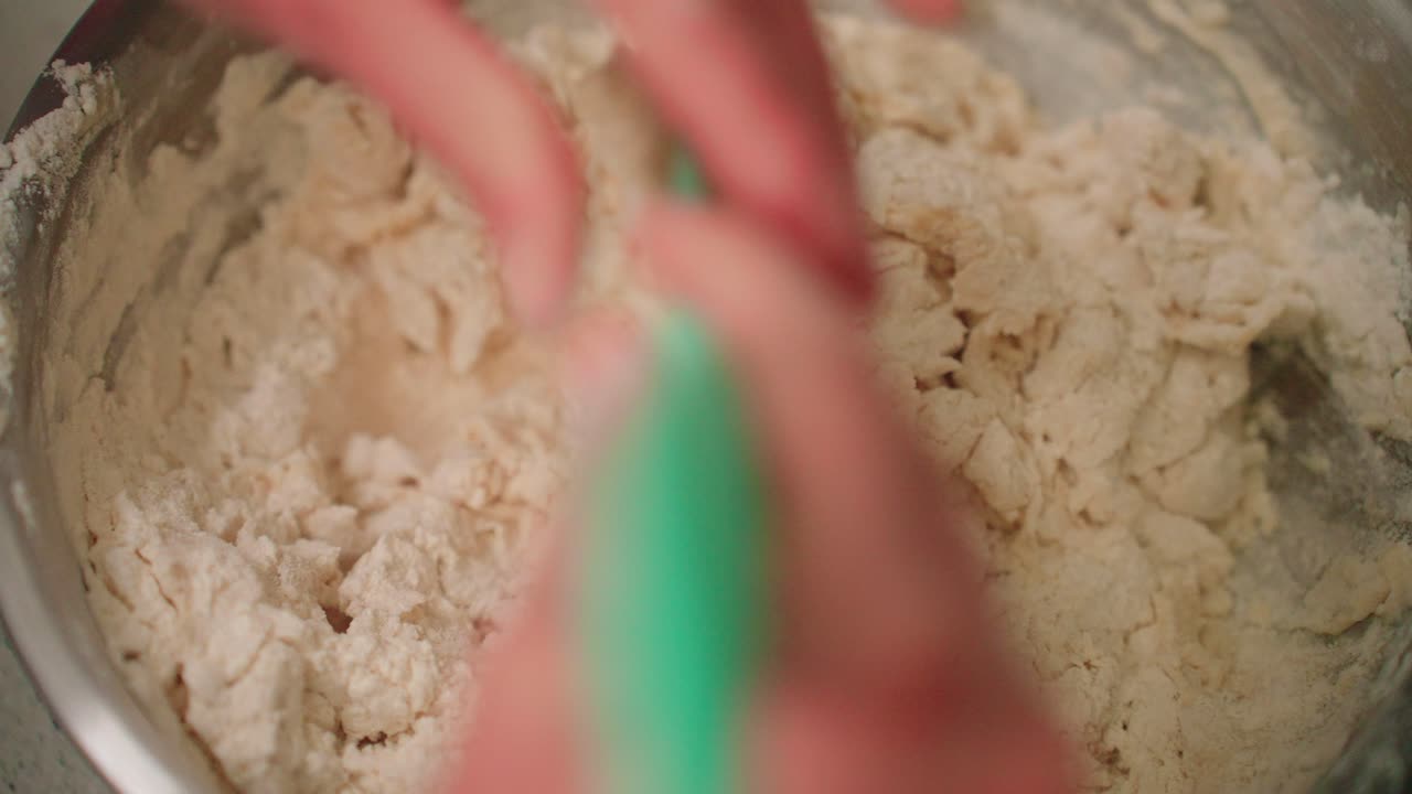Mixing dough with spatula and then by hand