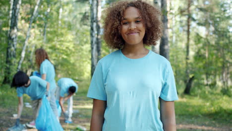 teen volunteer group cleaning up a forest