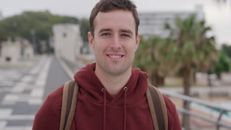 portrait charming young man laughing enjoying successful vacation lifestyle independent male student summer travel in urban city seaside background slow motion