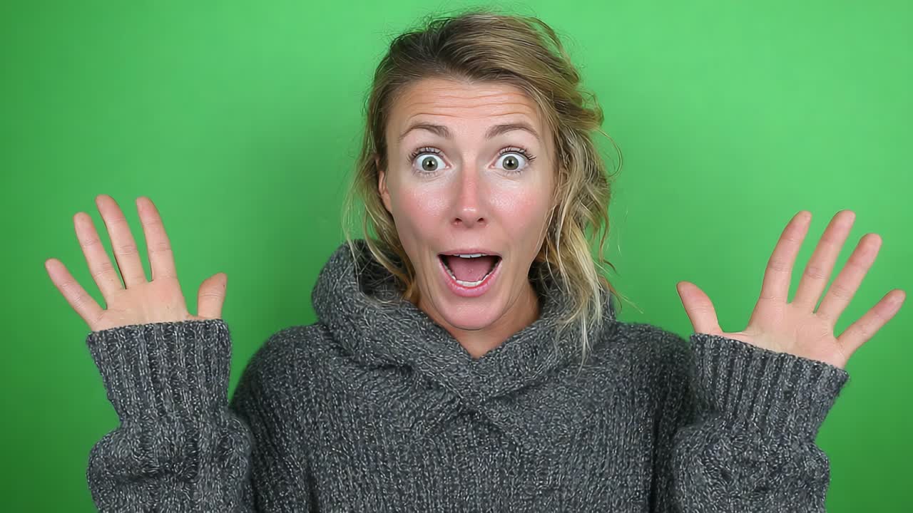 A Surprised Woman Expressing Joy with Raised Hands Against a Vibrant Green Background, Capturing the Essence of Excitement and Happiness in the Moment
