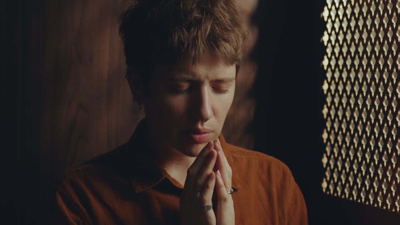 Young Faithful Female Penitent Praying in Confessional Stall