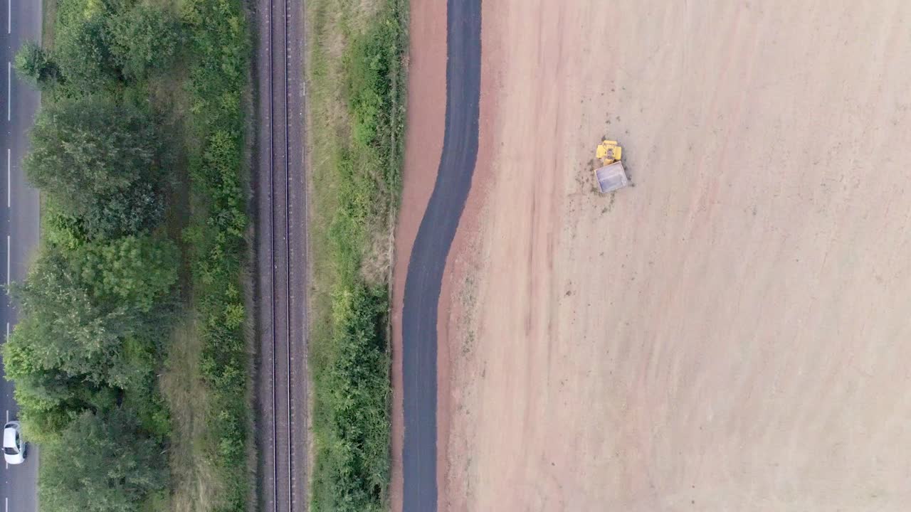 Aerial view of field with railroad tracks and road