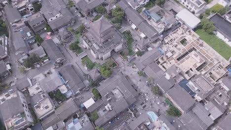 this aerial footage shows a bird's eye view of the wu hua tower located near the southern gate of dali's ancient city