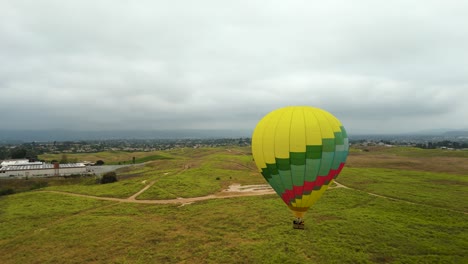 hot air balloon ride over fields on dramatic sunrise in temecula valley, riverside county, california