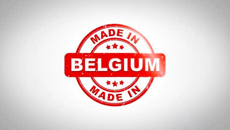 made in belgium  signed stamping text wooden stamp animation. red ink on clean white paper surface background with green matte background included.