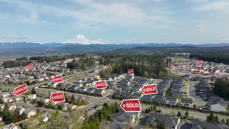 aerial view of a suburban neighborhood with "sold" signs appearing above houses