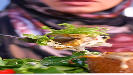 woman eating a salad with bread