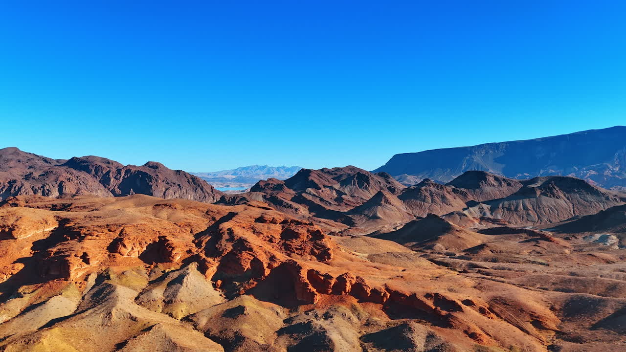 Lifeless brown bare rocks lit by the bright sin. Drone footage above the arid rocky scenery of Arizona, USA
