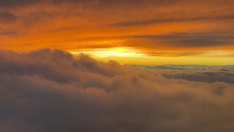 Spectacular-red-sunset-shot-from-an-airplane-cabin-while-flying-at-cruise-level-10000m-high-with-the-sun-veiled-ahead