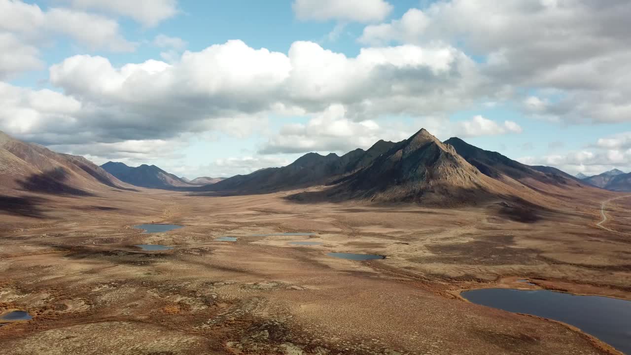 Dramatic landscape with clouds rolling on the mountains and tundra