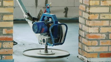 a worker with a power tool will cover a concrete stitch on the floor