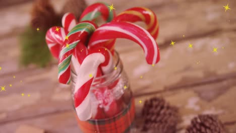 animation of yellow stars over christmas candy canes