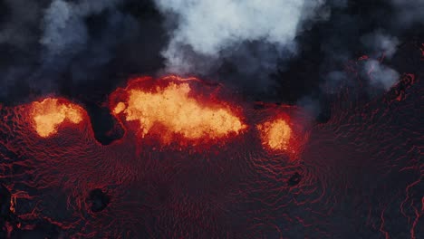 top down view of active fissure volcano with hot molten lava spewing on earth surface