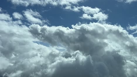 a pilot’s perspective: flying through a blue sky with some tiny cumulus