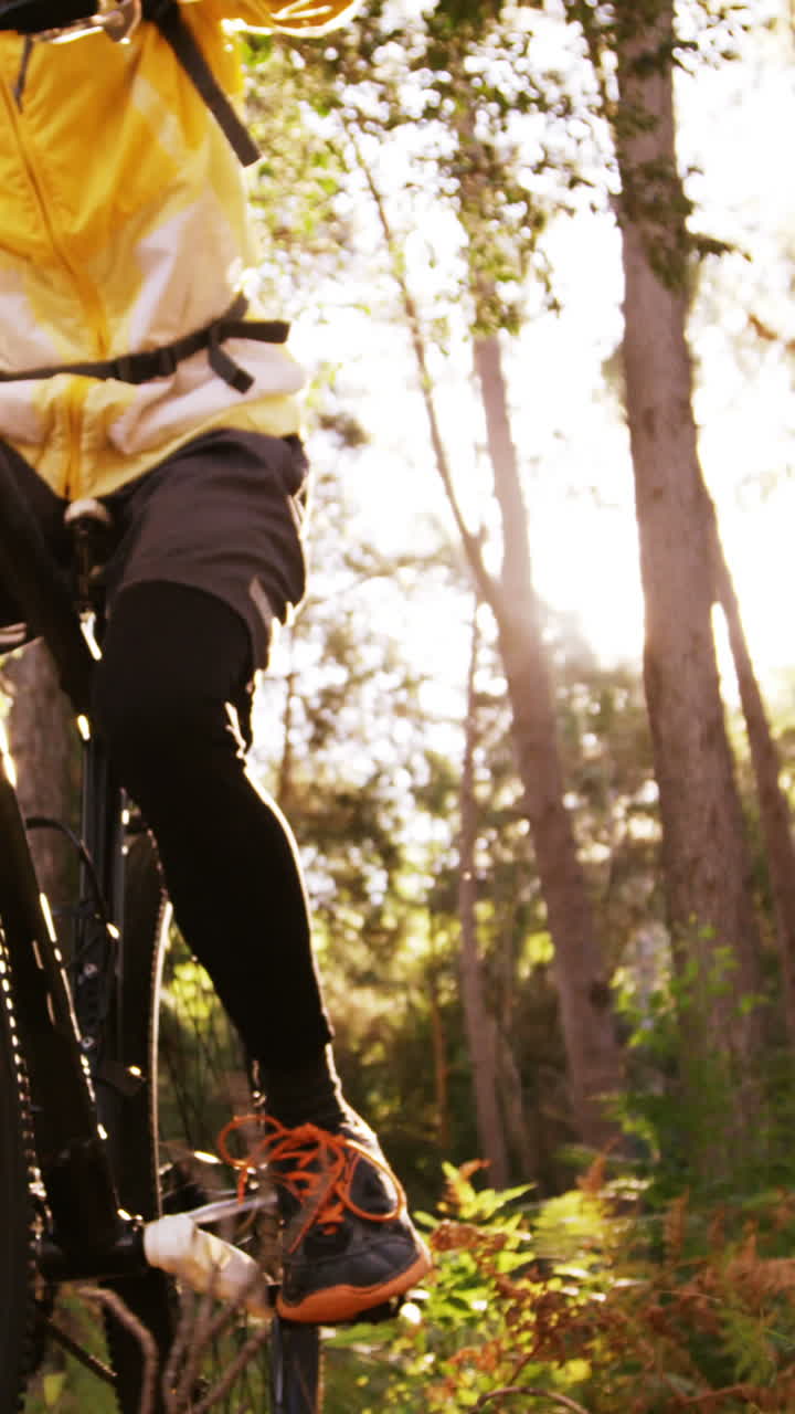 Female mountain biker riding in the forest
