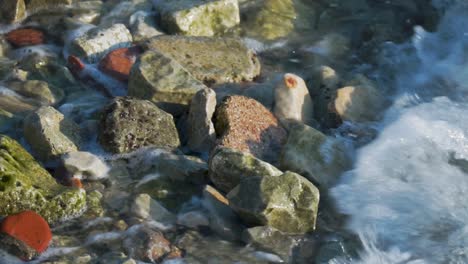 top view waves crashing over stones