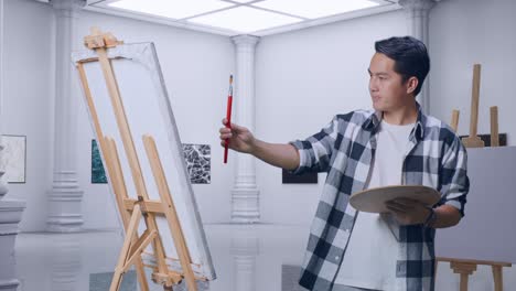 갤러리에서 오일 페인트와 으로 캔버스에 그림을 그리는 동안 페인트 브러쉬를 사용하여 그림 템플릿을 측정하는 아시아 남성 예술가