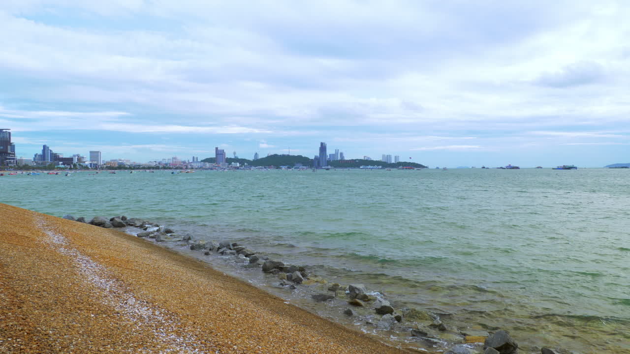 Pattaya beachfront facing the Gulf of Thailand, with the busy business centre in the background, in Chonburi province, Thailand