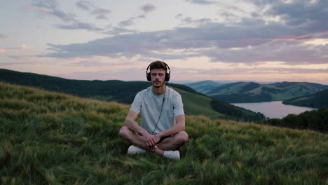 man relaxing in nature with headphones
