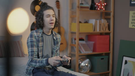 teenager gaming in bedroom