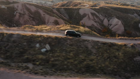 Rental-Car-Driving-Through-Cappadocia-Trail-On-A-Sunny-Day-In-Turkey