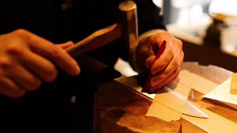 craftsman shaping knife blade with precision