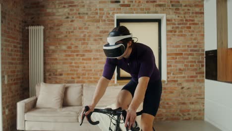 man using vr headset for indoor cycling workout at home.