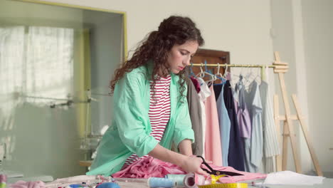 dressmaker cutting fabric.