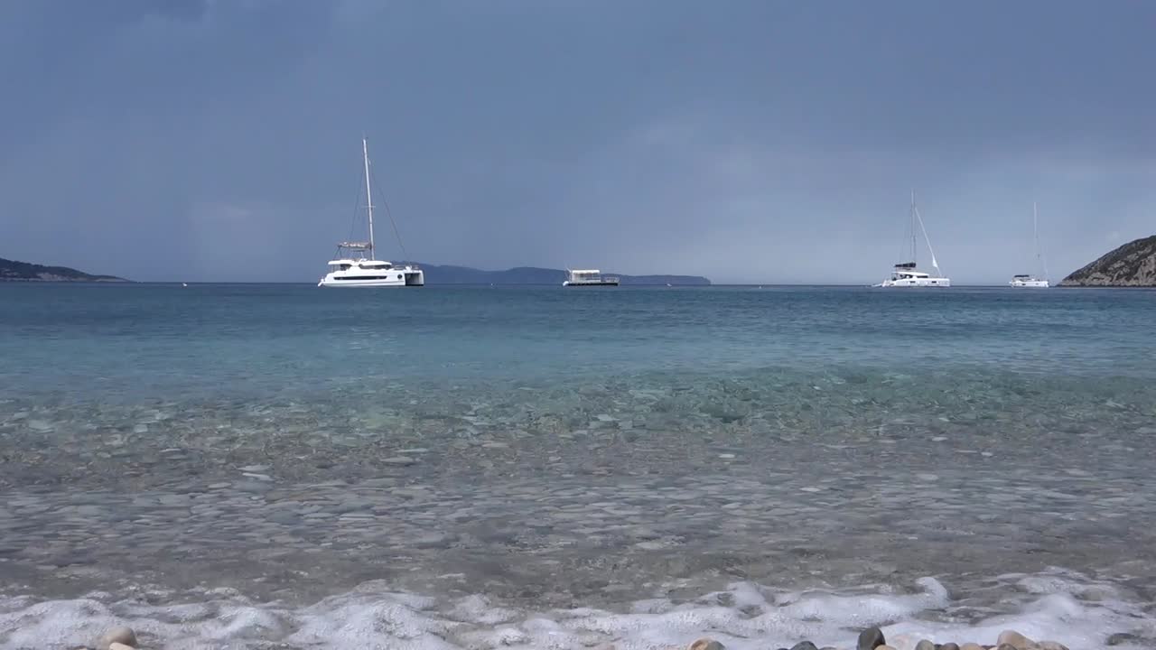 low angle of small ripples in the clear sea by the beach in Komiza, Vis island, Croatia