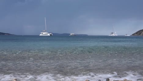 low angle of small ripples in the clear sea by the beach in komiza, vis island, croatia