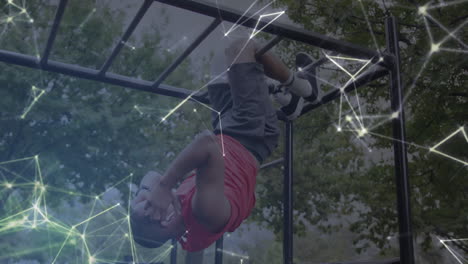 animation of communication network over male athlete with prosthetic leg exercising on monkey bars