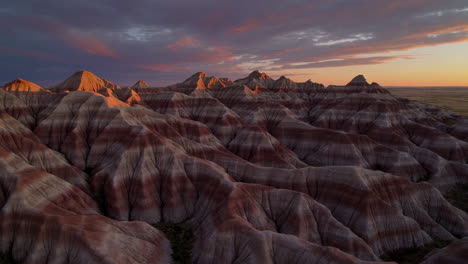 dramatic sunset over layered badlands formations