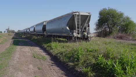a freight train drives away in a rural area.