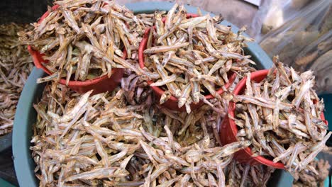 Close-up-of-a-bowl-of-loose-dried-smoked-small-fish-at-a-market-stall-in-Dili,-Timor-Leste,-Southeast-Asia