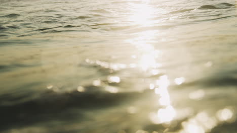 Glistening-bright-closeup-light-dances-on-ocean-water-surface-in-slow-motion