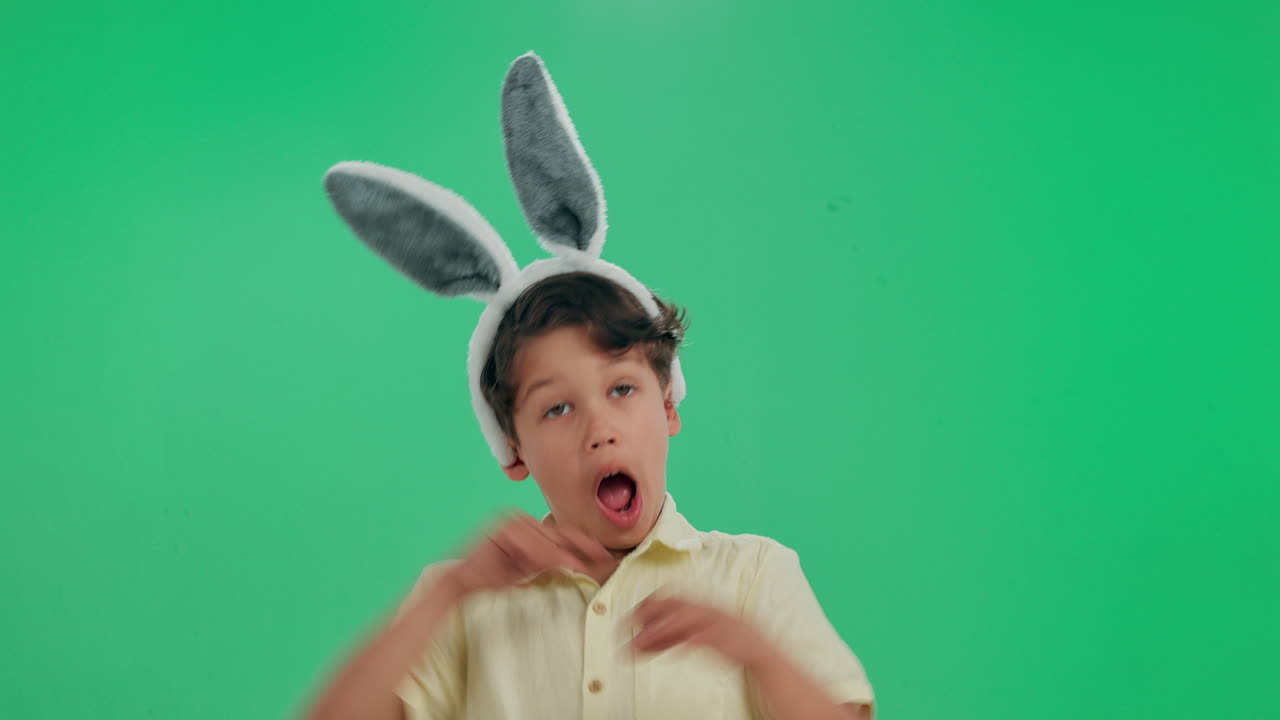 Boy with bunny ears on green screen