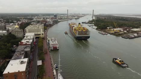 approaching a large cargo ship barge moving through savannah river in georgia