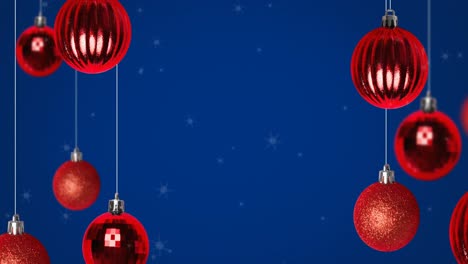 Animation-of-glowing-blue-light-trails-over-christmas-red-baubles-on-blue-background