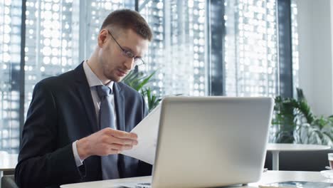 two multiethnic coworkers analyzing financial papers