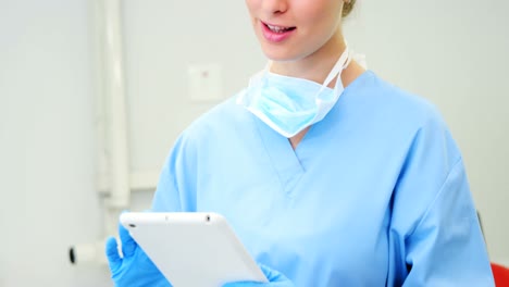 female nurse using digital tablet in clinic