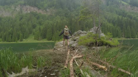 Mujer-Turista-Deportiva-Va-De-Excursión-Cerca-De-Un-Lago-Verde