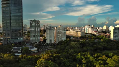 anacaona 27 tower skyscraper and enriquillo lake, santo domingo cityscape in dominican republic. aerial sideways