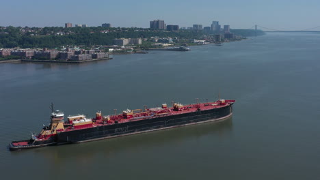 a drone view of a large red barge on the hudson river in ny on a sunny day